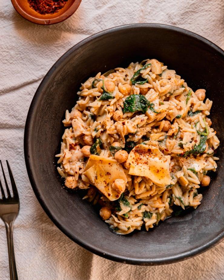 Overhead shot of a vibrant Spinach and Artichoke Orzo Pasta Salad