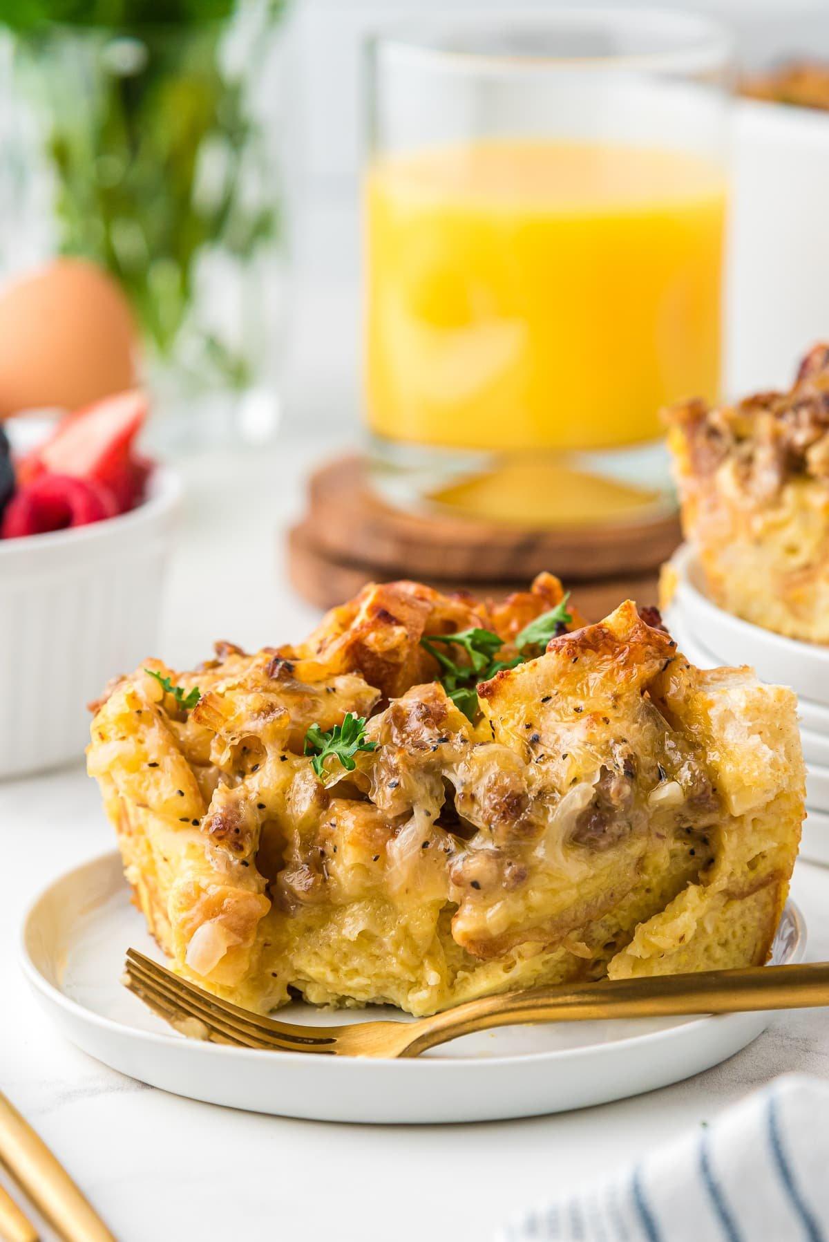 baked golden brown overnight breakfast casserole slice being served