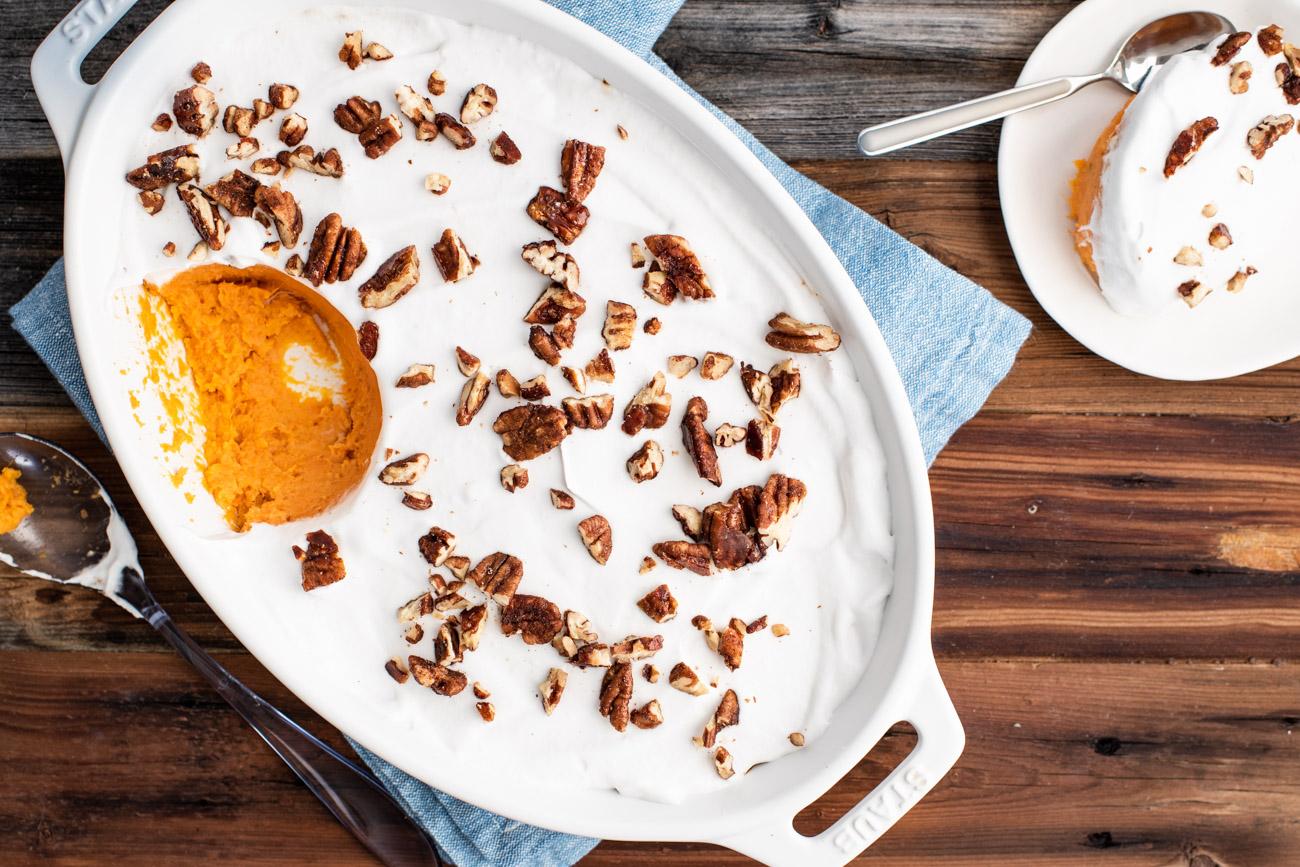 Sweet potato casserole in a baking dish, garnished with toasted coconut, ready to be served