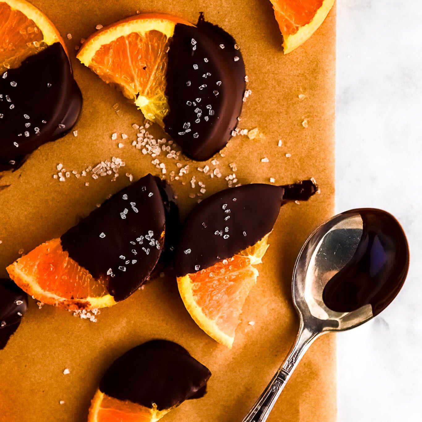 close up of orange zest falling into melting chocolate, rich texture