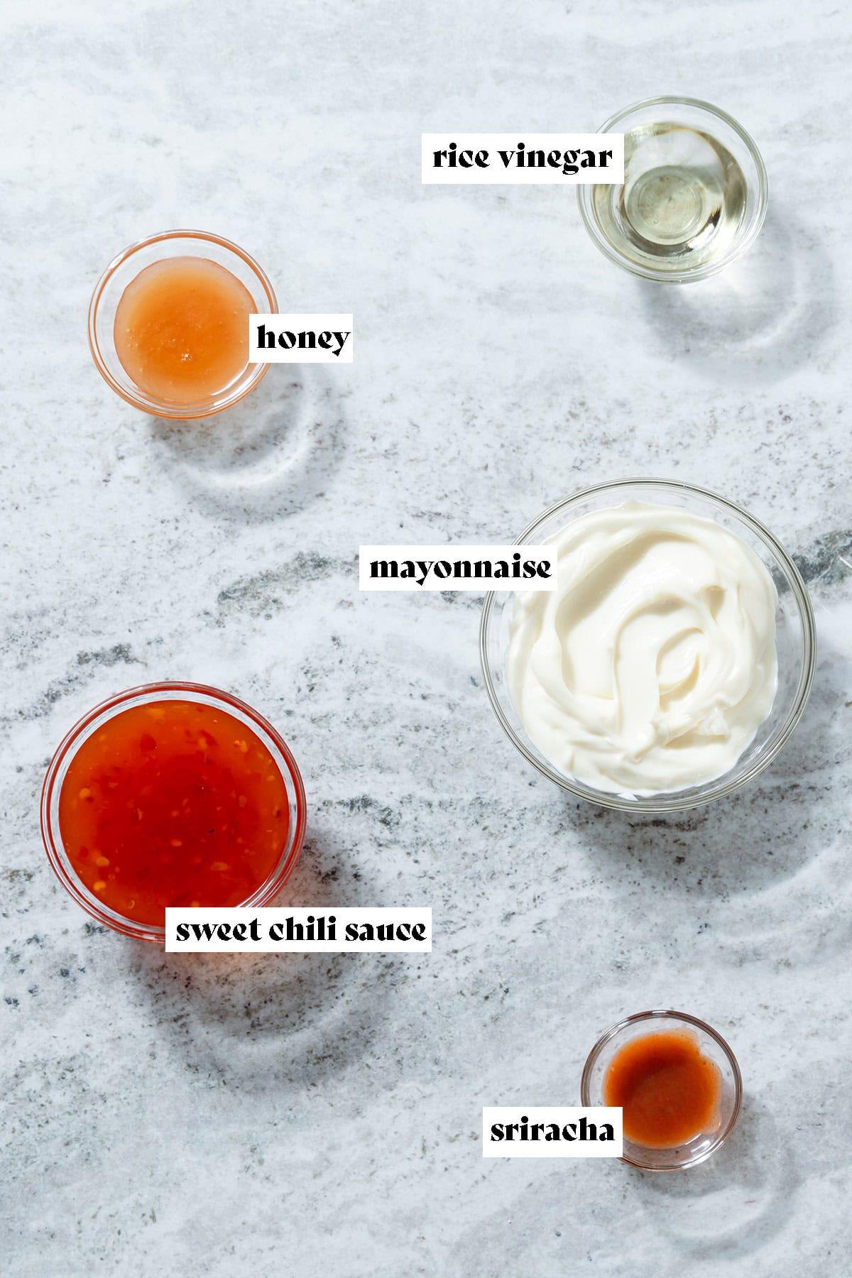 Ingredients for Bang Bang Sauce laid out beautifully: mayonnaise, sweet chili, sriracha, honey