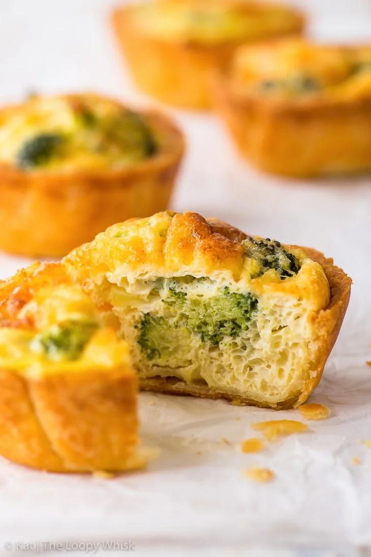 close up of mini quiches with toppings