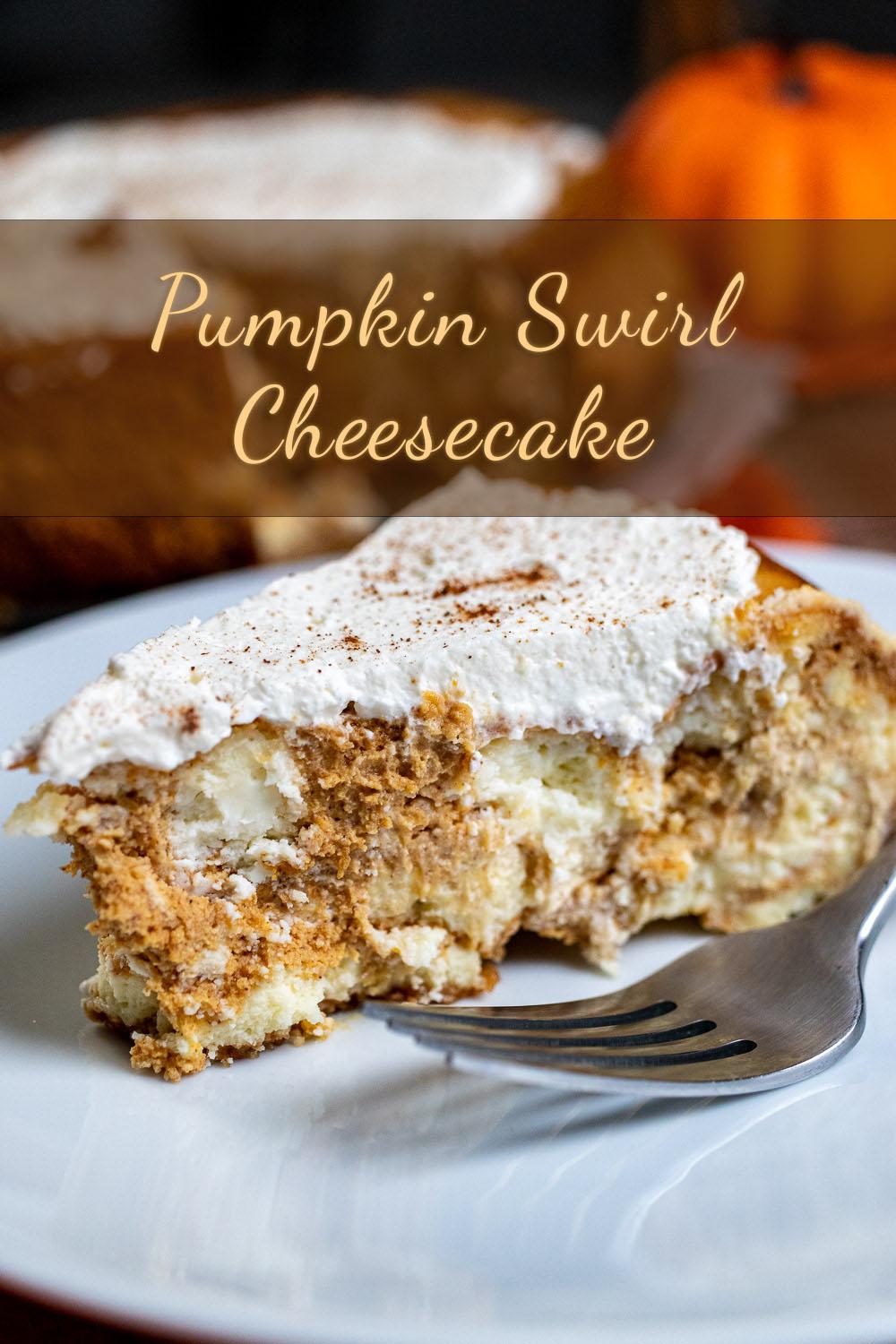 slice of pumpkin cheesecake with a visible swirl, on a white plate with a fork
