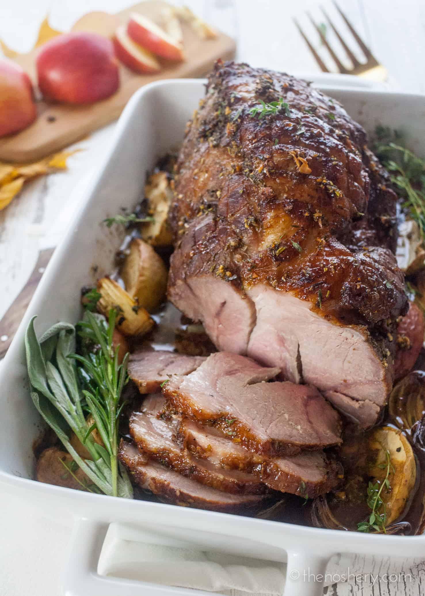 slow cooker filled with cider-brined pork shoulder, cooking