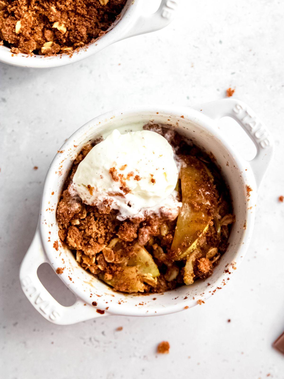 overhead shot of spiced apple crumble bars with a scoop of vanilla ice cream