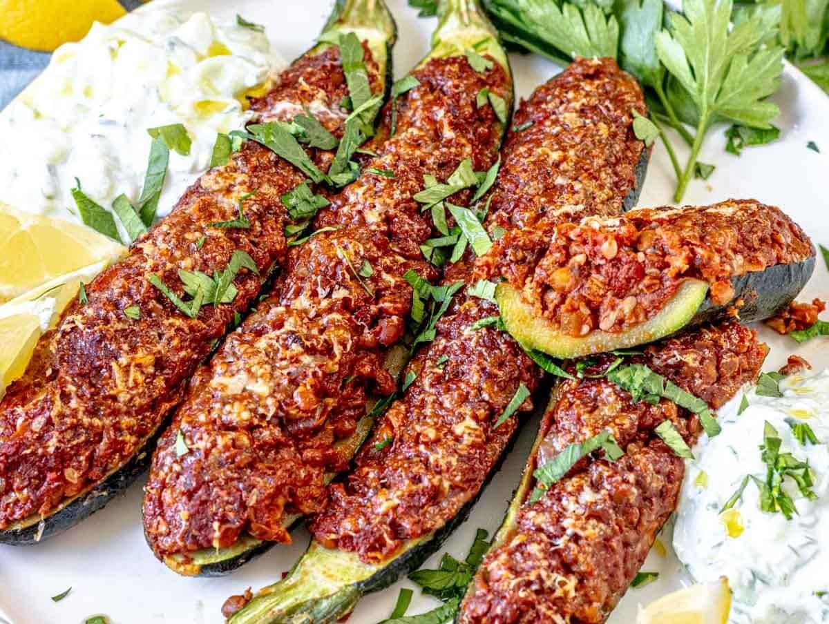 Close-up shot of a freshly baked lemon herb chicken stuffed zucchini boat, garnished with parsley