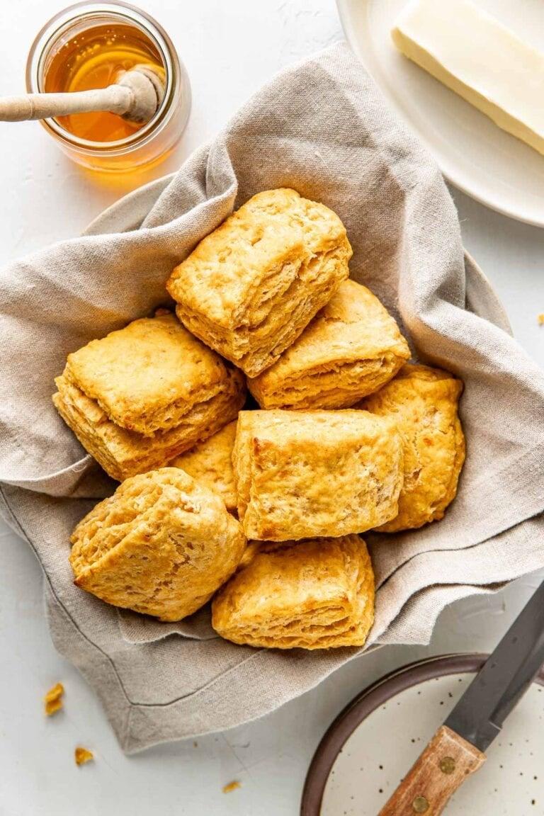rustic kitchen counter with ingredients for sweet potato biscuits: sweet potatoes, flour, butter, milk