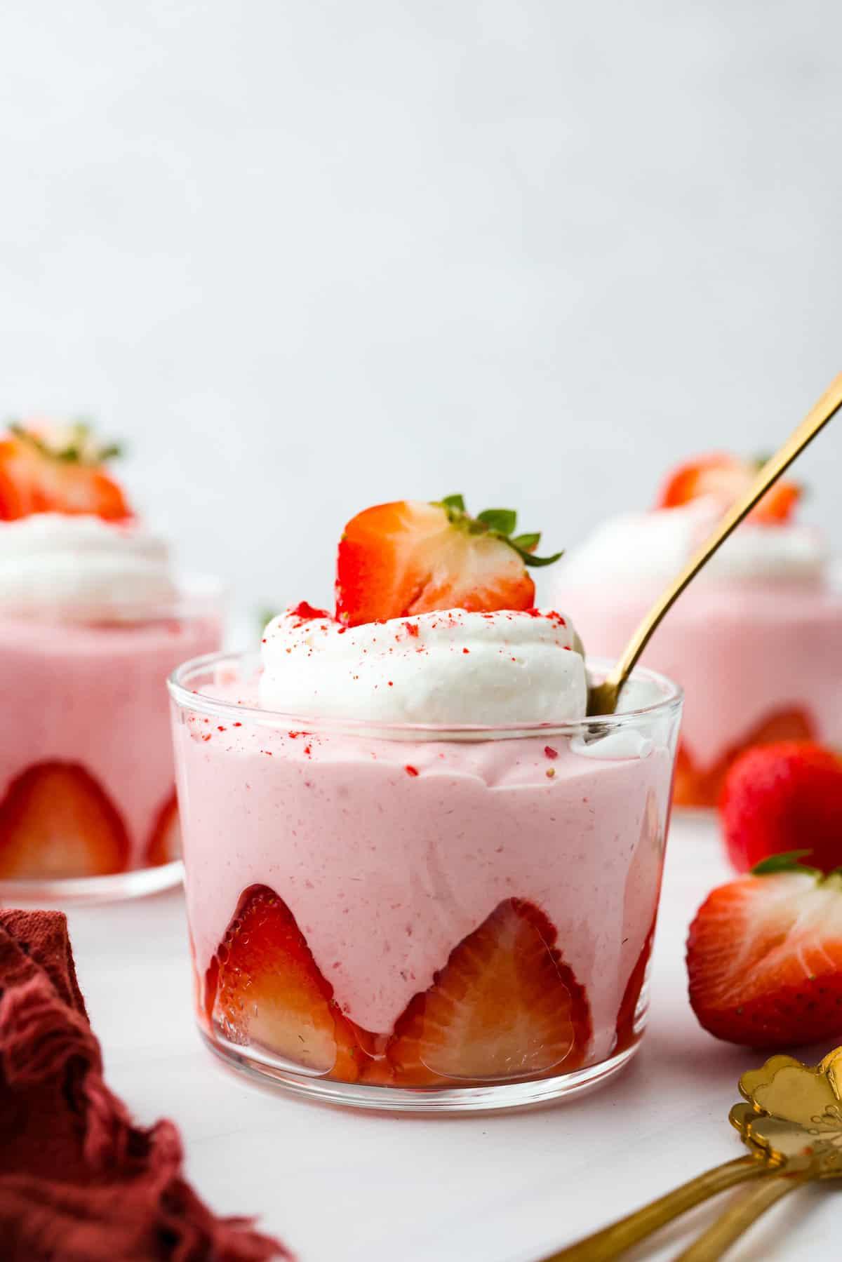 individual servings of bourbon strawberry mousse topped with fresh strawberries