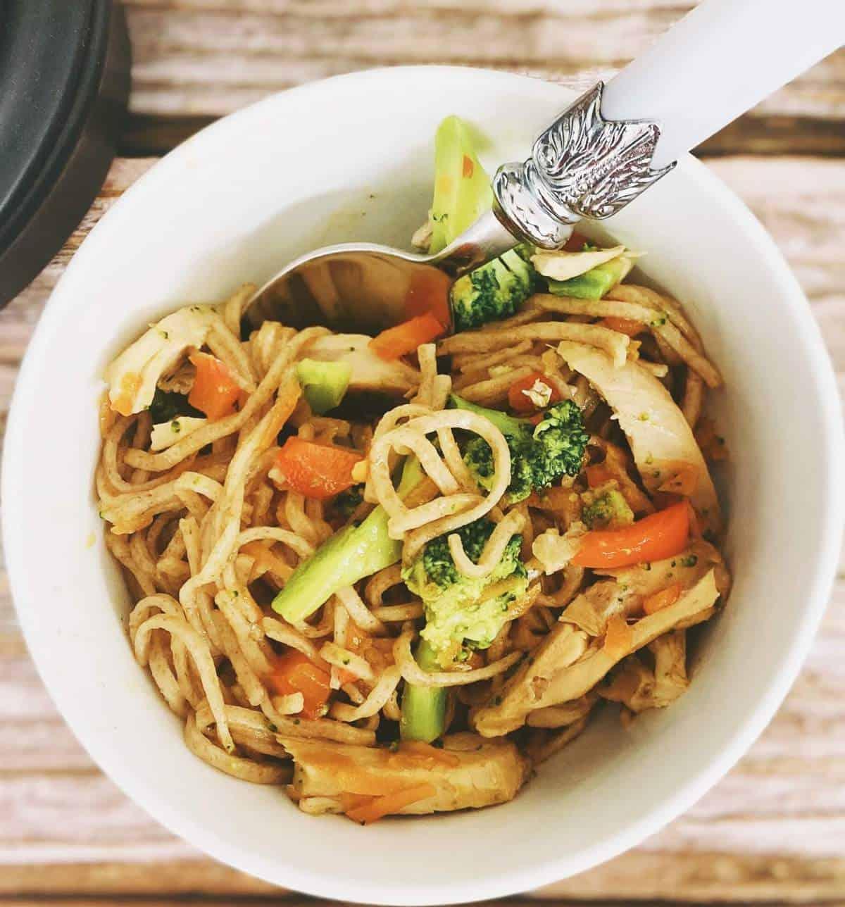 kids eating chicken stir-fry with noodles