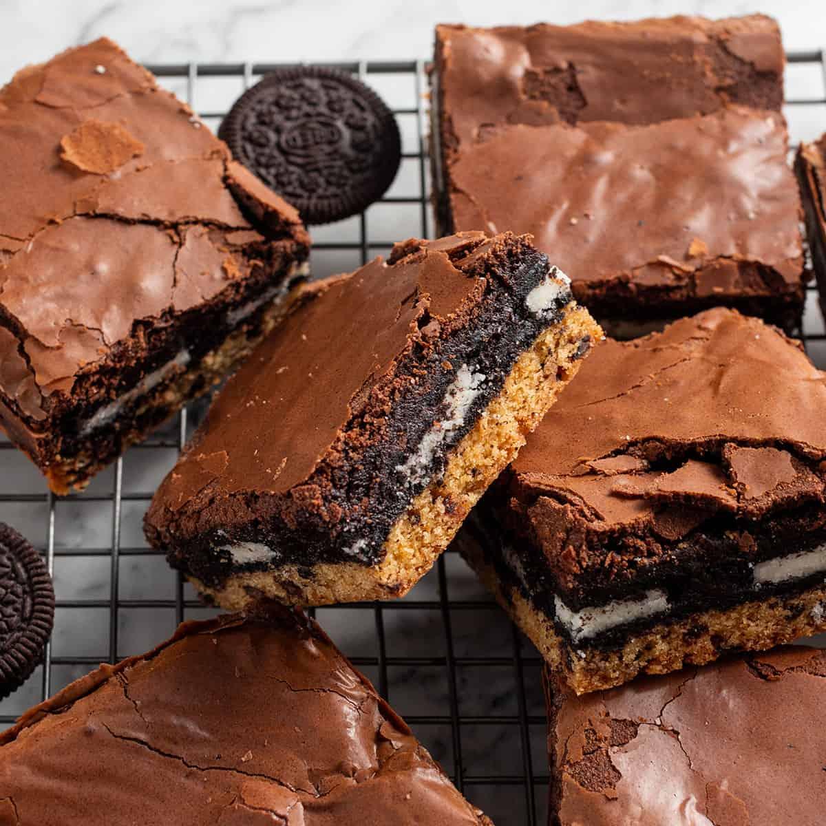 close up shot of gooey chocolate brownie cookie bars on a cooling rack, rich chocolate and chewy texture visible