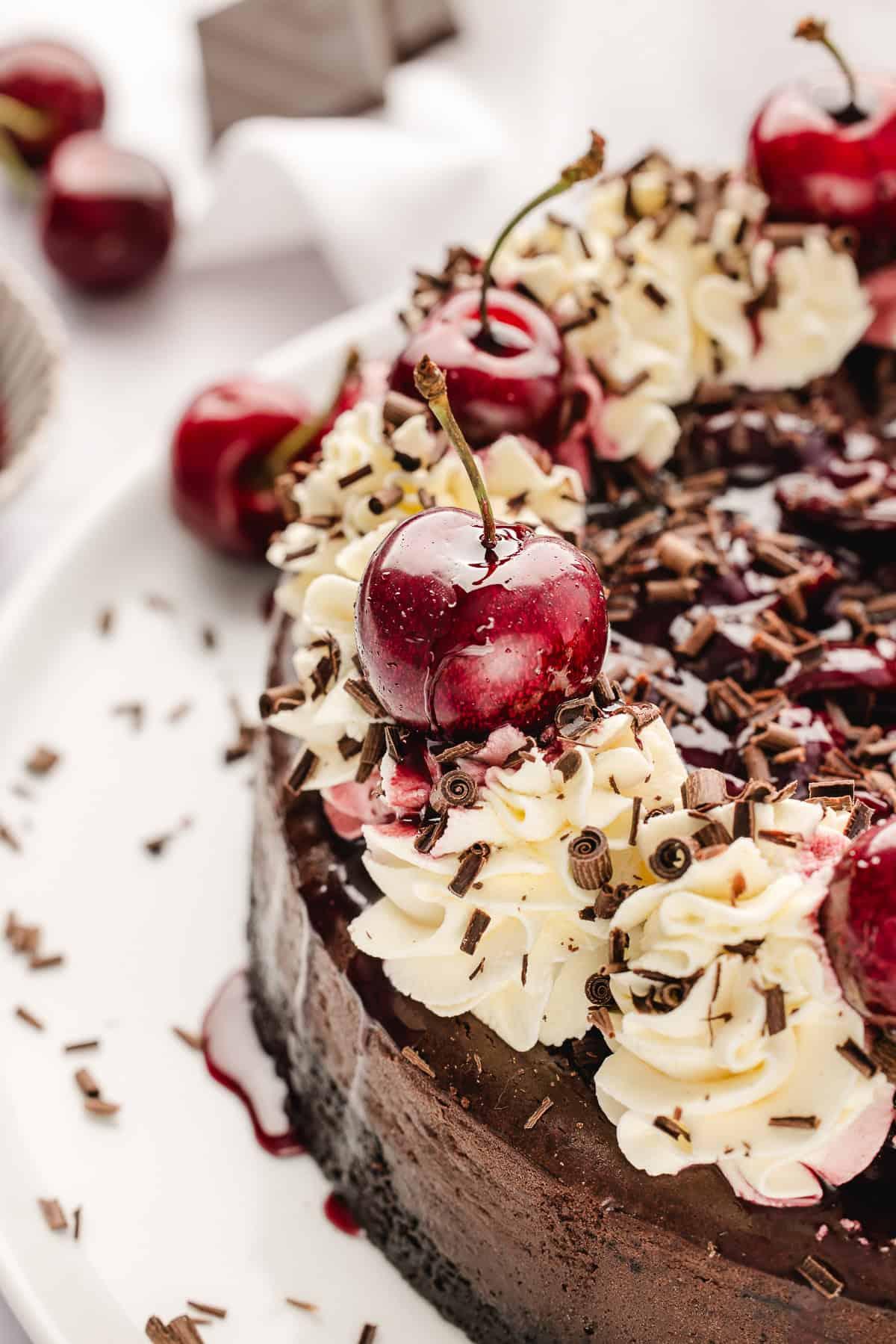 Overhead shot of the complete Black Forest Cheesecake with whipped cream and chocolate shavings