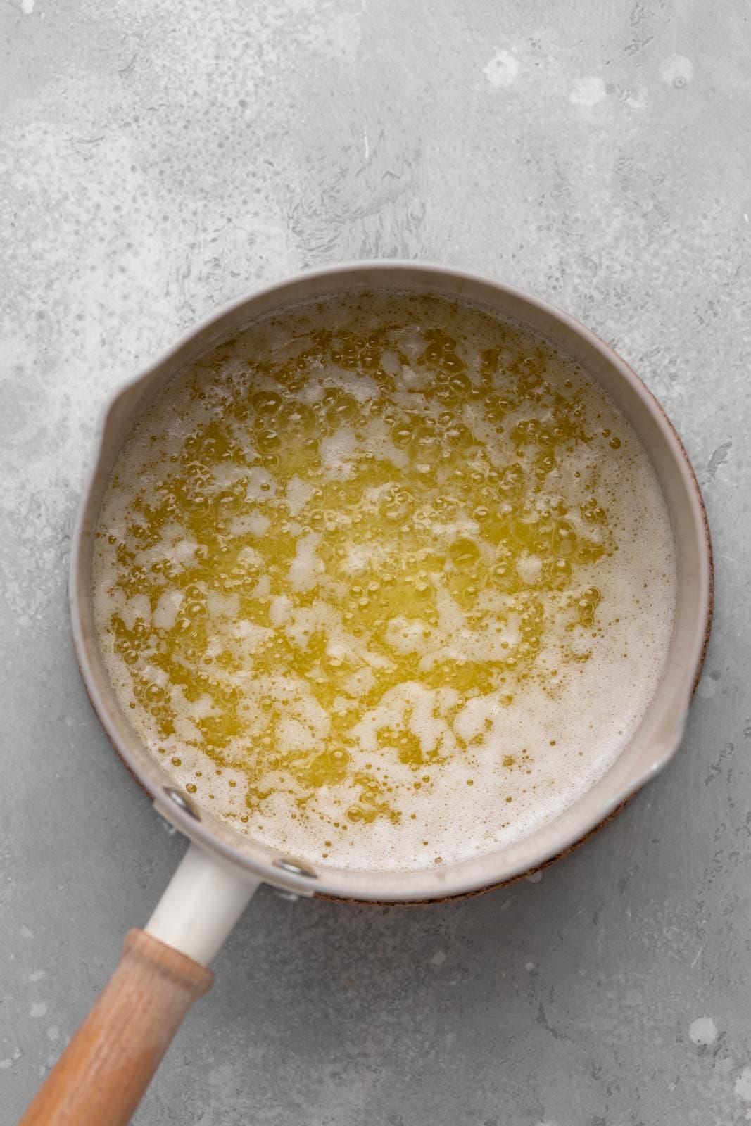 close-up of brown butter bubbling in a saucepan