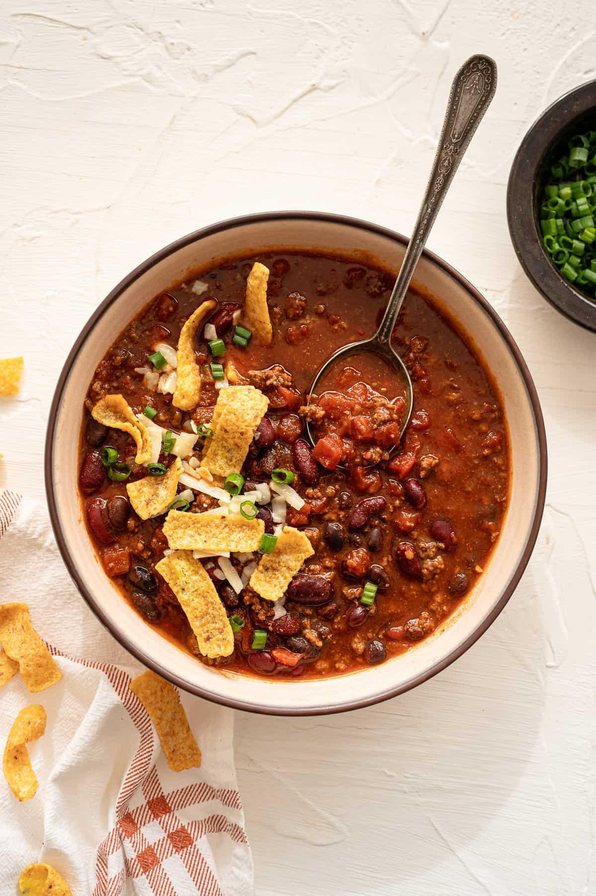 a pot of beef and bean chili simmering on a stove