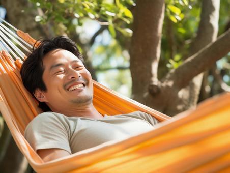 person relaxing in hammock at campsite