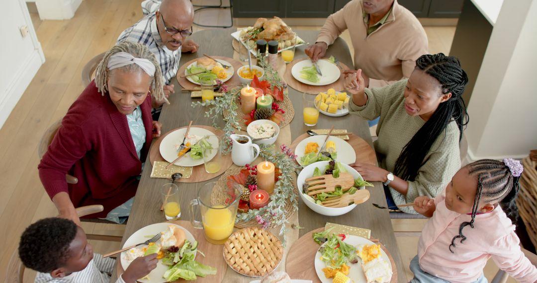 Happy multi-generational family enjoying a festive Thanksgiving dinner, with a vibrant sweet potato casserole at the center