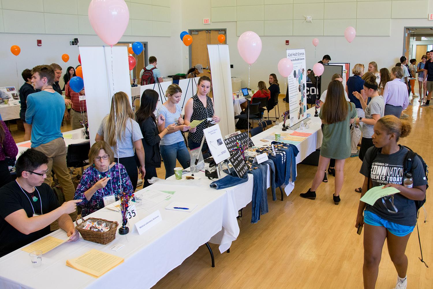 students at a college fair exploring different majors