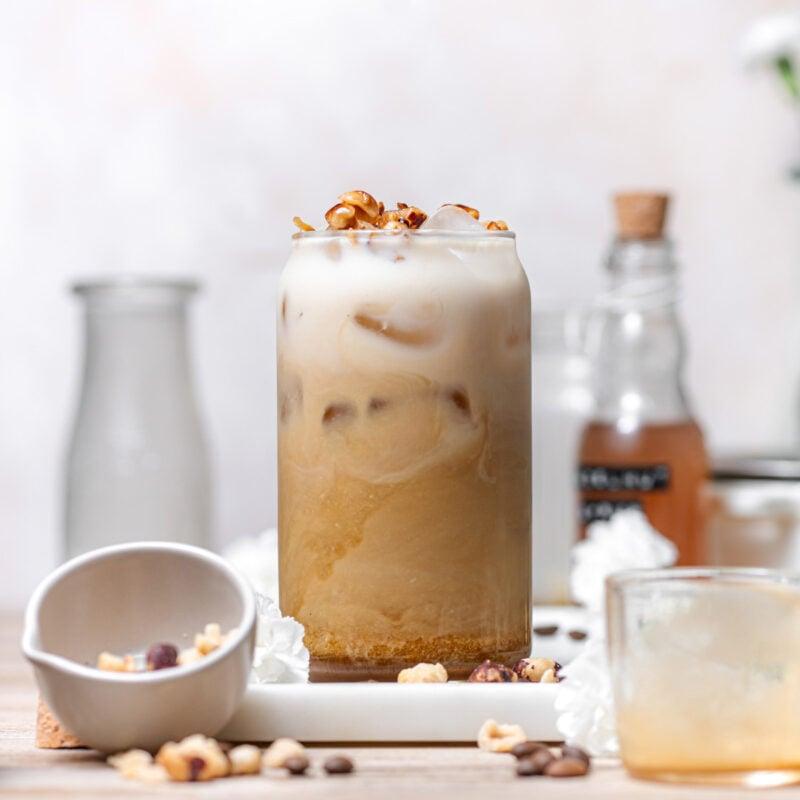 iced chai latte with coffee and hazelnut drizzle