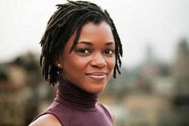 woman smiling confidently with her short dreads