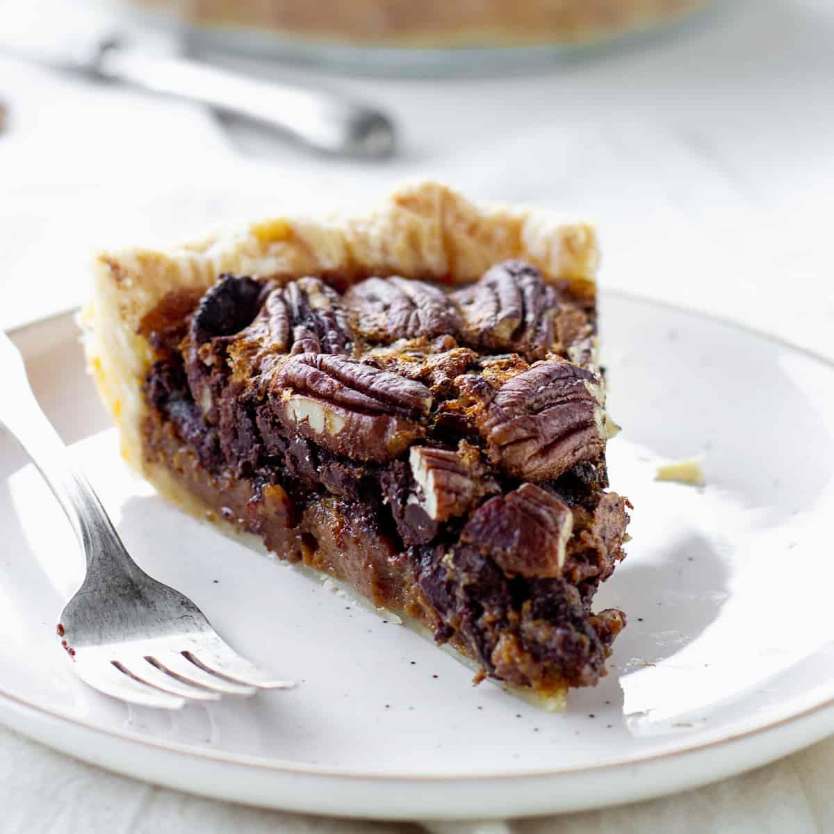 Ingredients for chocolate pecan pie laid out on a kitchen counter