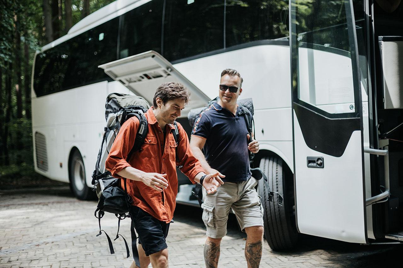 group of friends boarding a private shuttle bus at an airport