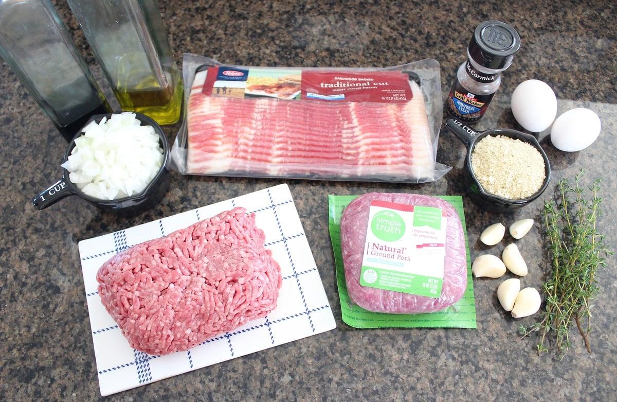 ingredients laid out on a wooden countertop for making bacon-wrapped meatloaf