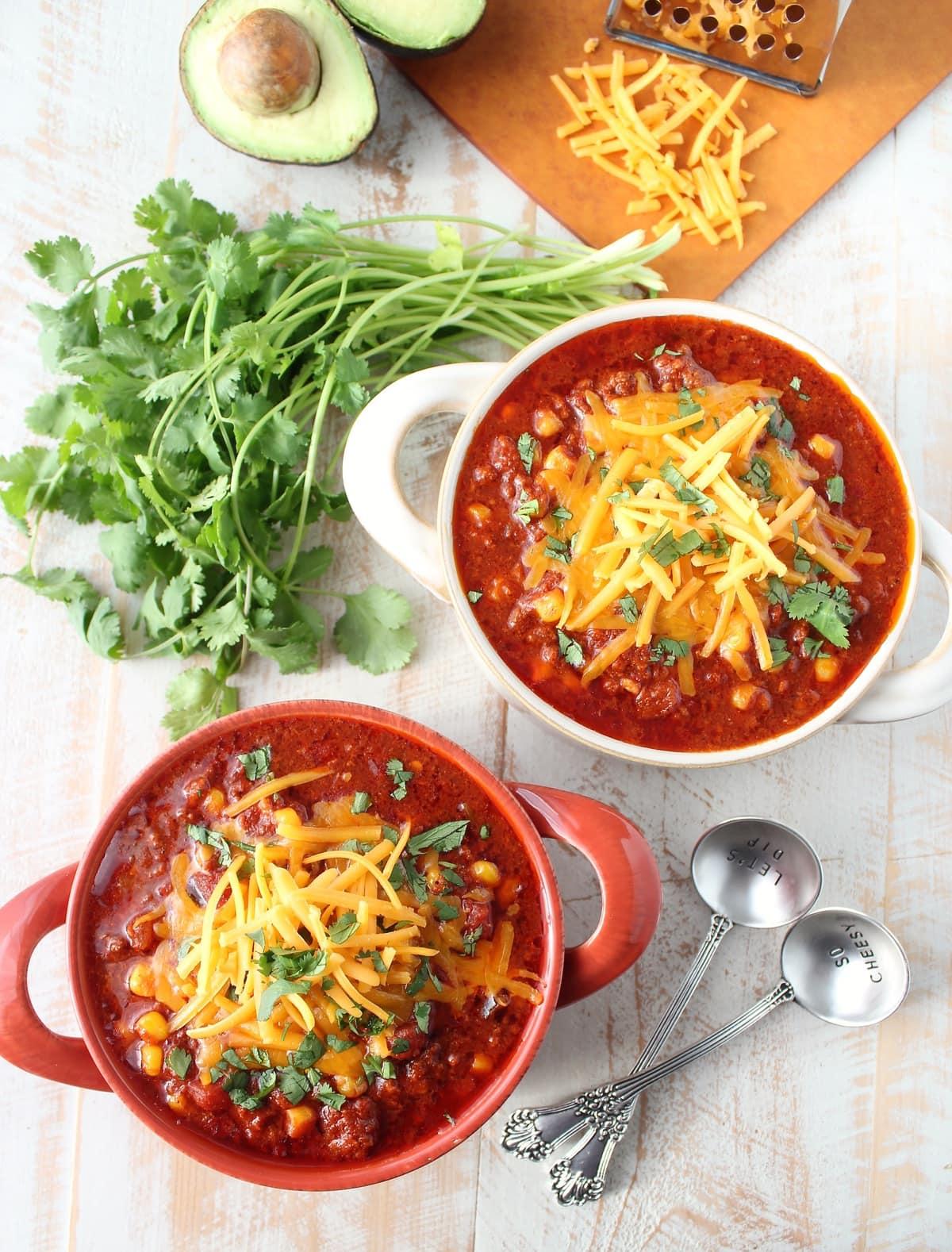 overhead shot of sweet corn and chorizo chili in a rustic bowl