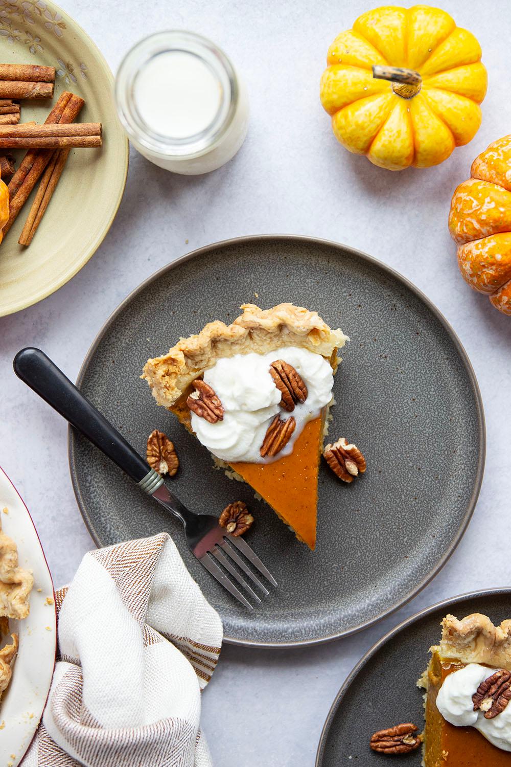 Overhead shot of an entire pumpkin pie with intricate whipped cream decoration