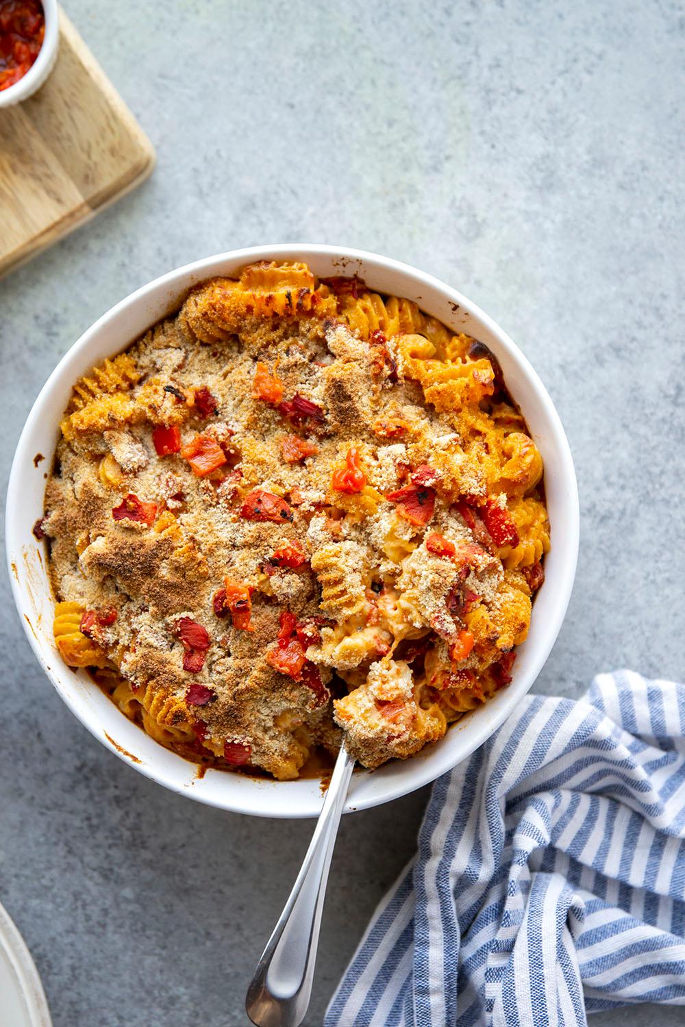 overhead shot of memorial day mac and cheese with red pepper stars in a baking dish