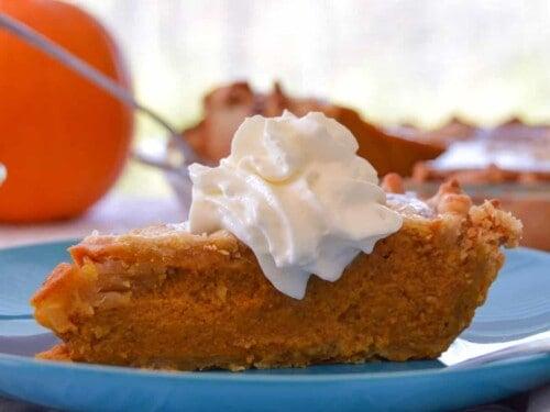 Hands preparing pie crust for rustic pumpkin pie, with flour dust