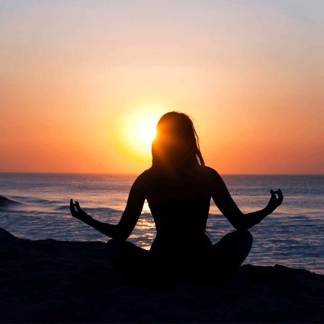 woman meditating at sunrise