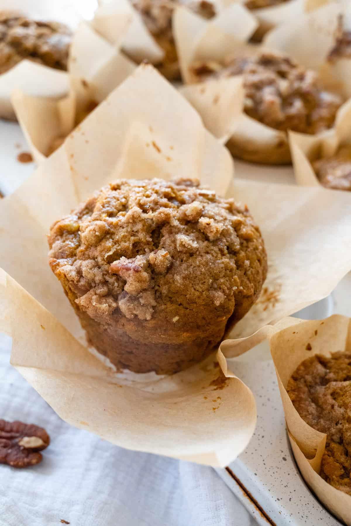 close up of a pumpkin streusel muffin being held