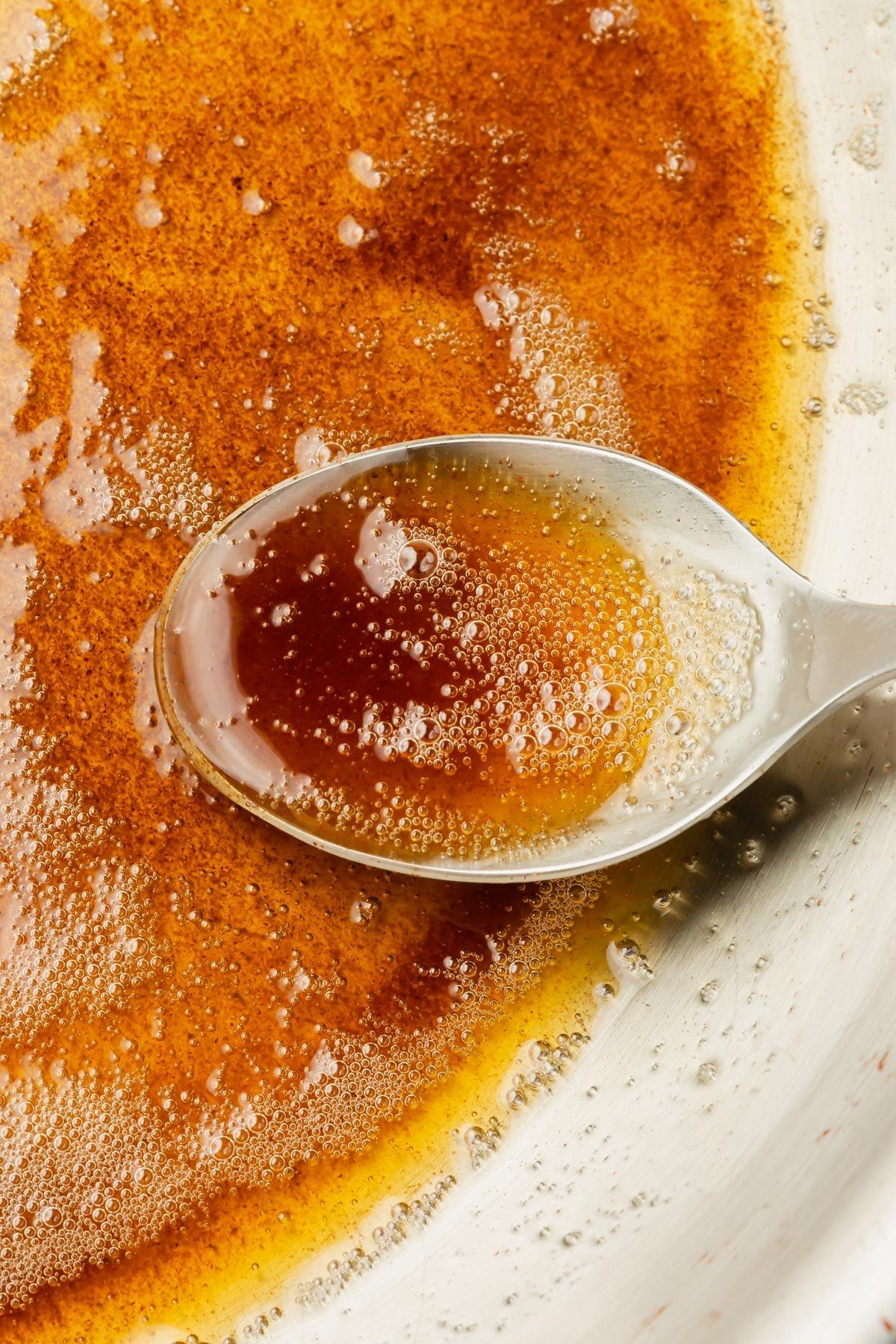 browning butter in a saucepan, showing golden amber color and foam