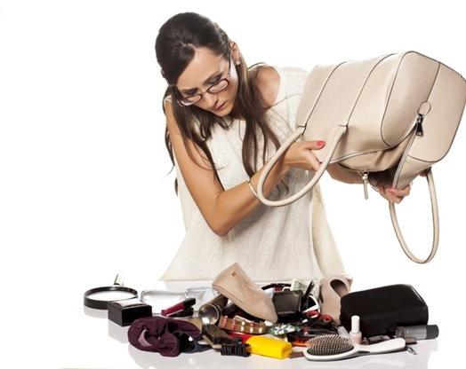 woman emptying the contents of her handbag