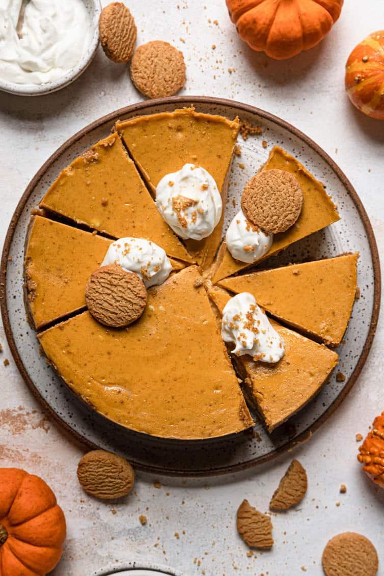 Overhead shot of a beautifully baked pumpkin cheesecake cooling on a wire rack