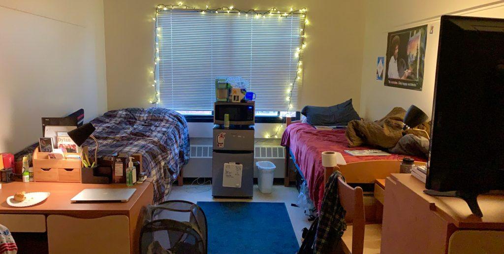 student decluttering dorm room