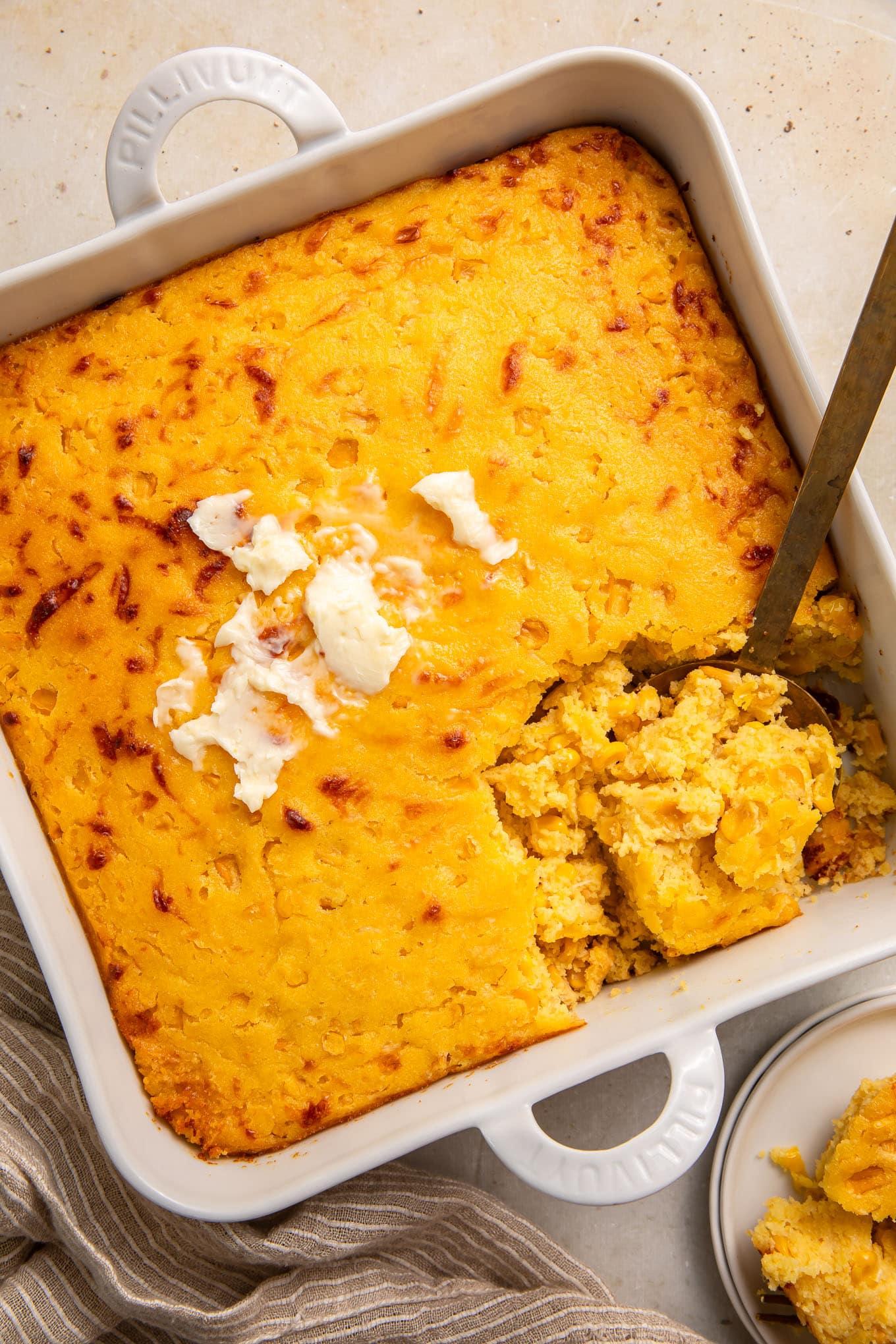 Delicious Southern corn casserole with golden-brown crust, steam rising, on a rustic table
