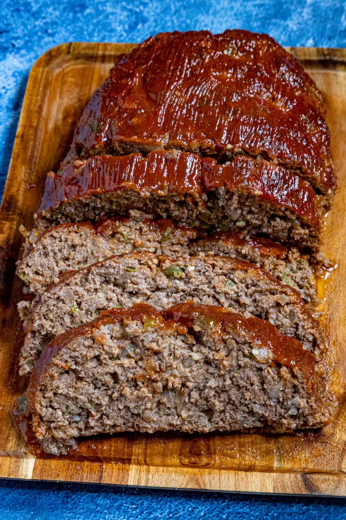 finished meatloaf on a cutting board, ready to be sliced