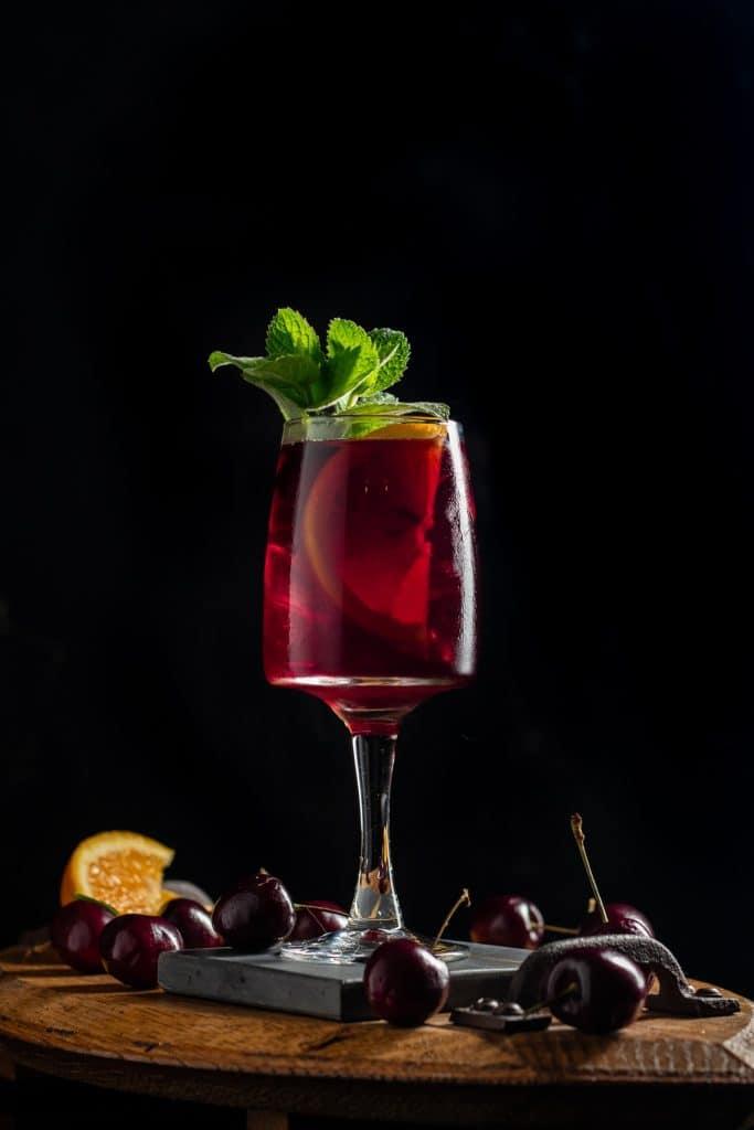 ruby red sangria being poured into a elegant glass