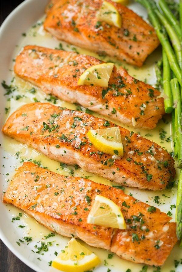 pan-frying lemon garlic salmon fillets in a skillet