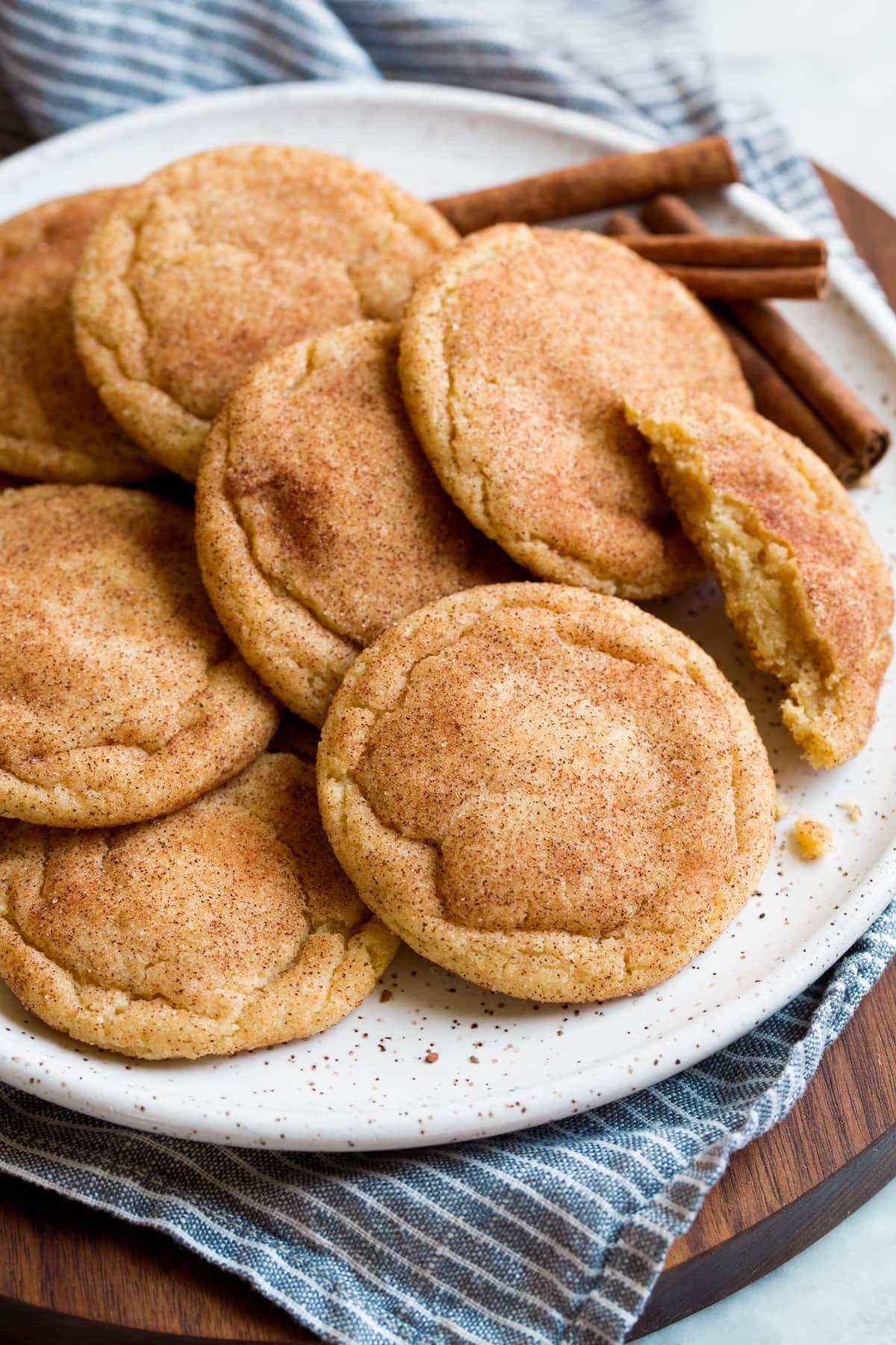 close-up of a perfectly baked snickerdoodle cookie with visible cracks and cinnamon sugar