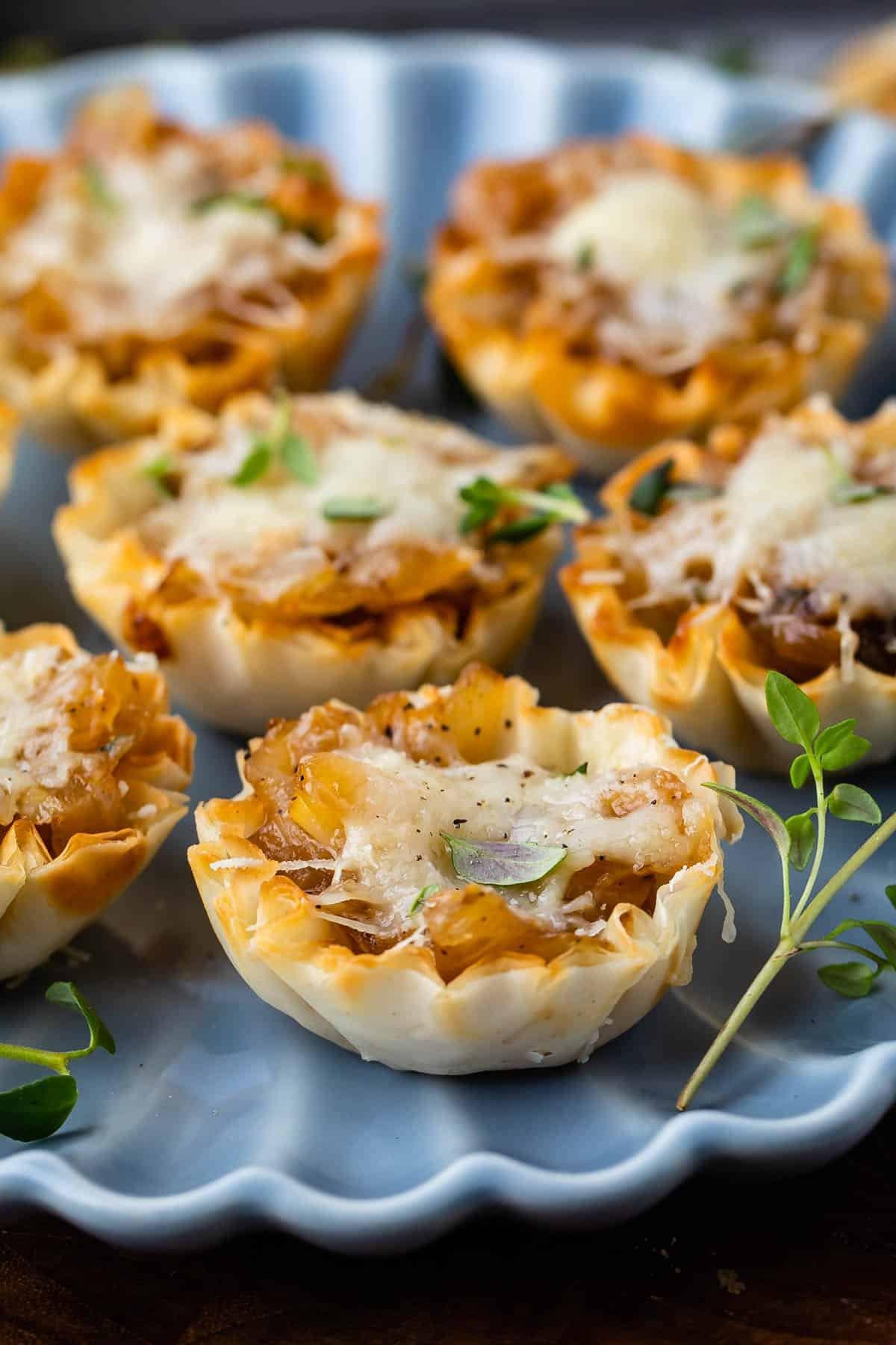 plate of mini caramelized onion tartlets ready to serve