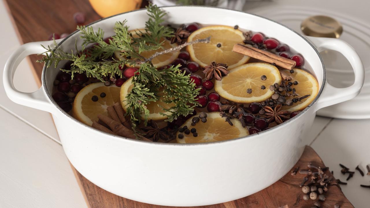 cranberries simmering gently in a saucepan on a stovetop, steam rising