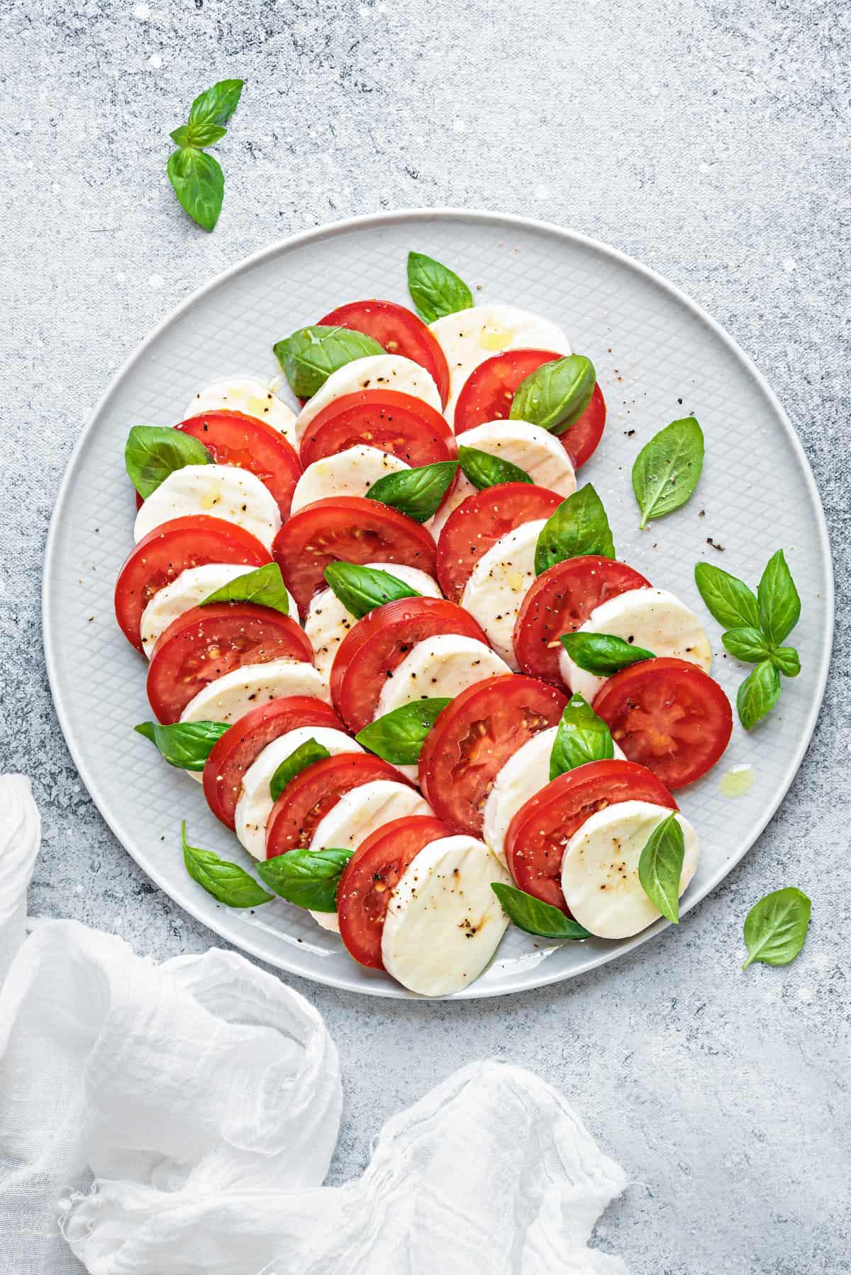 close-up of Caprese salad with cappelletti on a plate, showcasing the layers of ingredients