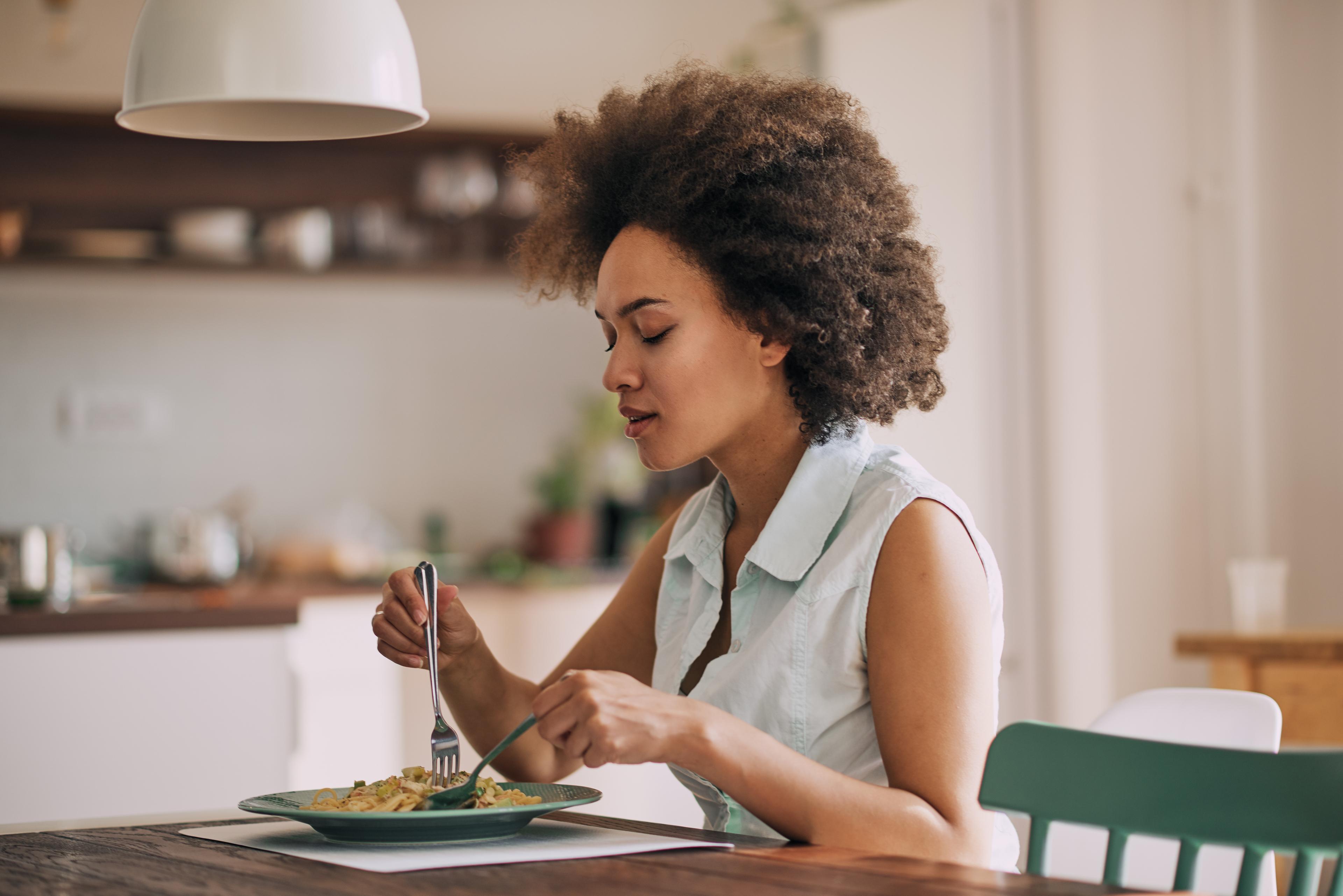 woman practicing mindful eating at a table