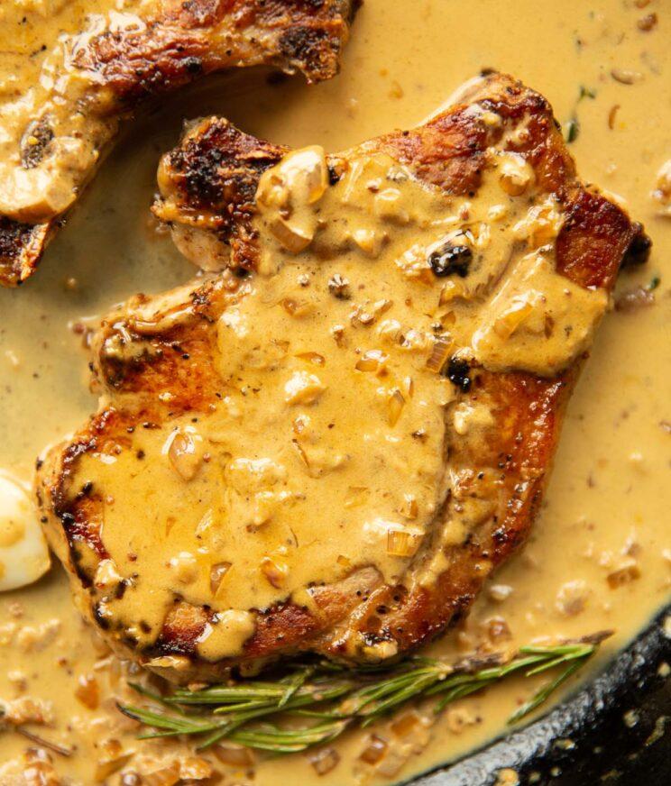 Close-up of pork chops with sauce drizzled over them