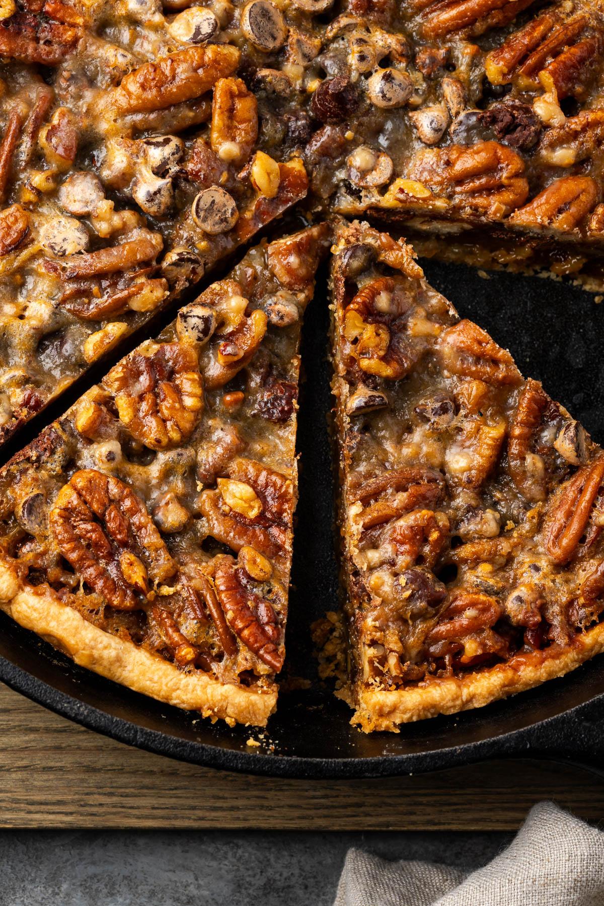 Homemade chocolate pecan pie cooling on a wire rack with a golden crust
