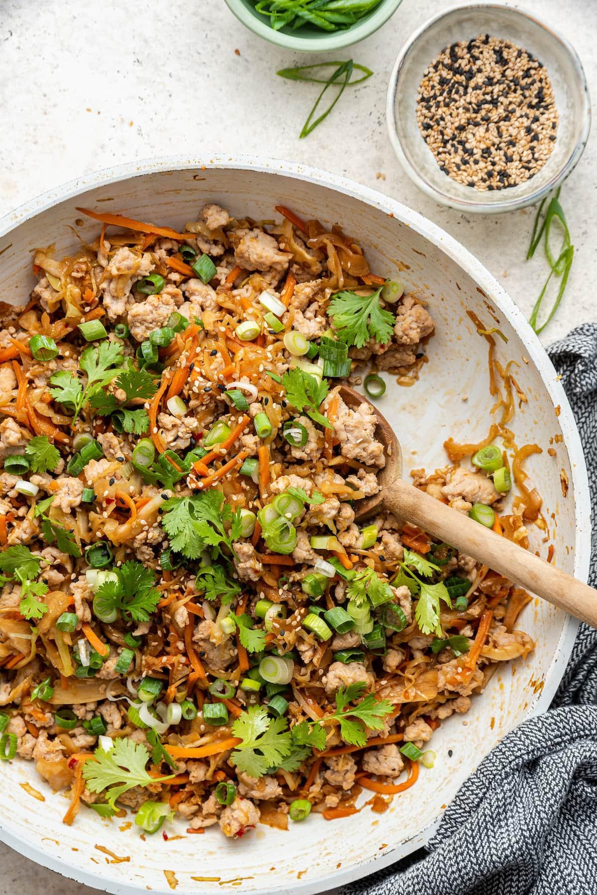 close up shot of spicy corn and avocado egg roll fillings in a bowl