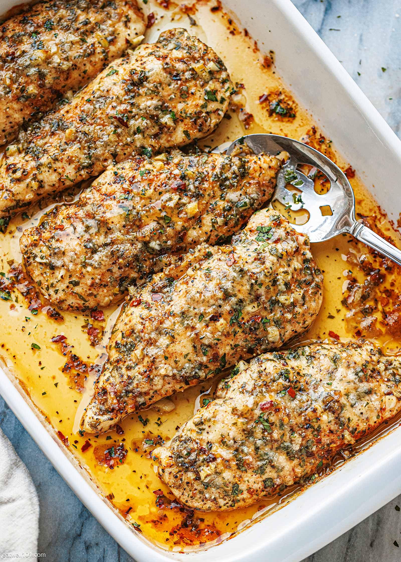 Garlic Parmesan Baked Chicken Breasts, golden brown, with fresh parsley garnish