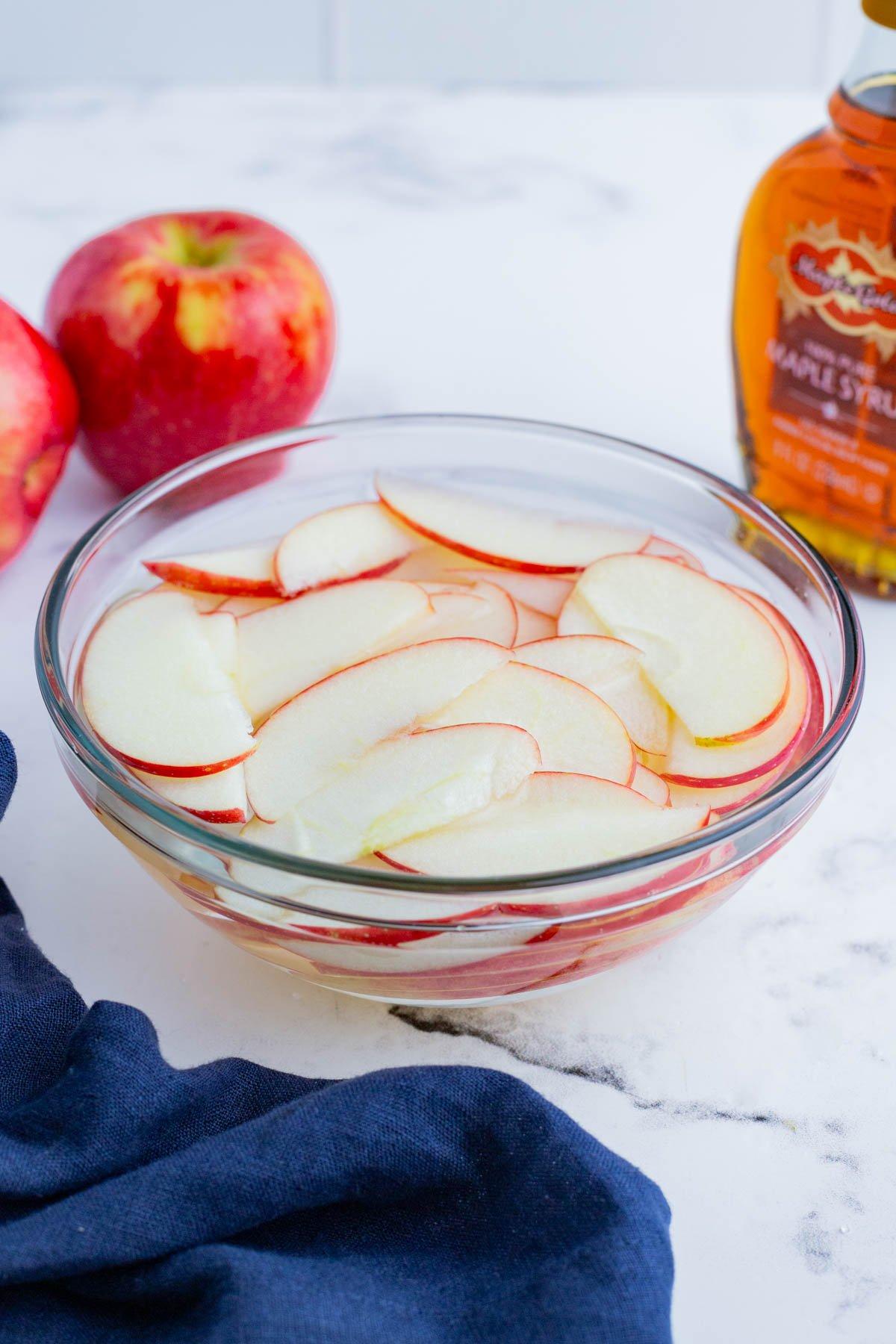 apple slices soaking in blue colored water