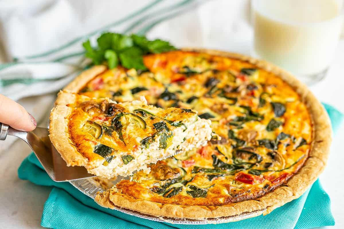 a family enjoying slices of summer vegetable quiche at a brunch table